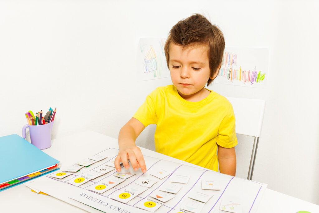 Little boy learning at a desk.