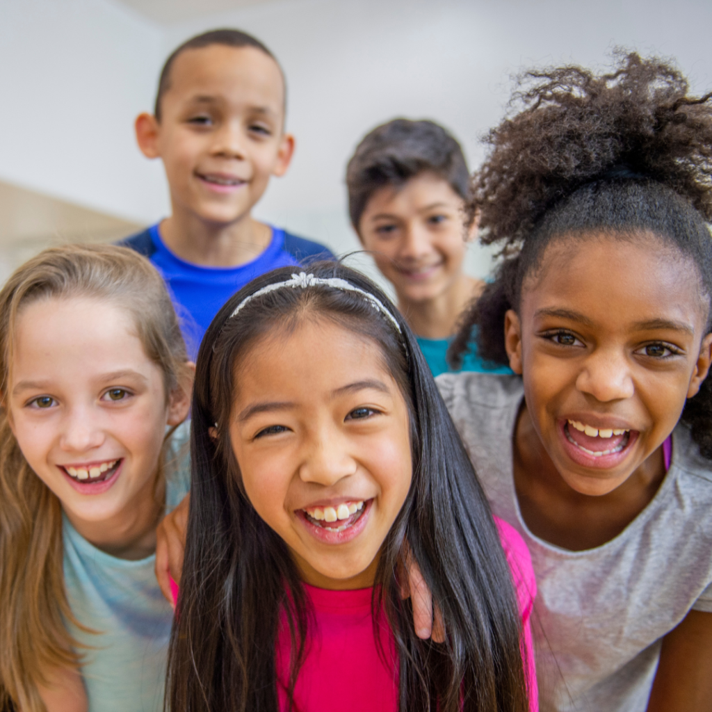 Diverse group of kids smiling at the camera