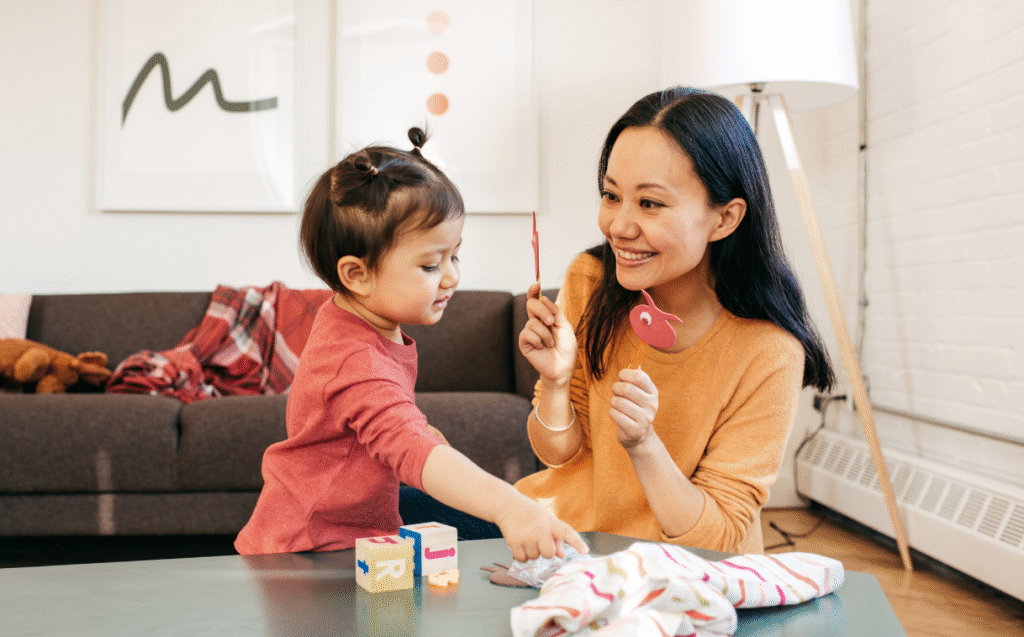 mother holding up educational tools to teach daughter